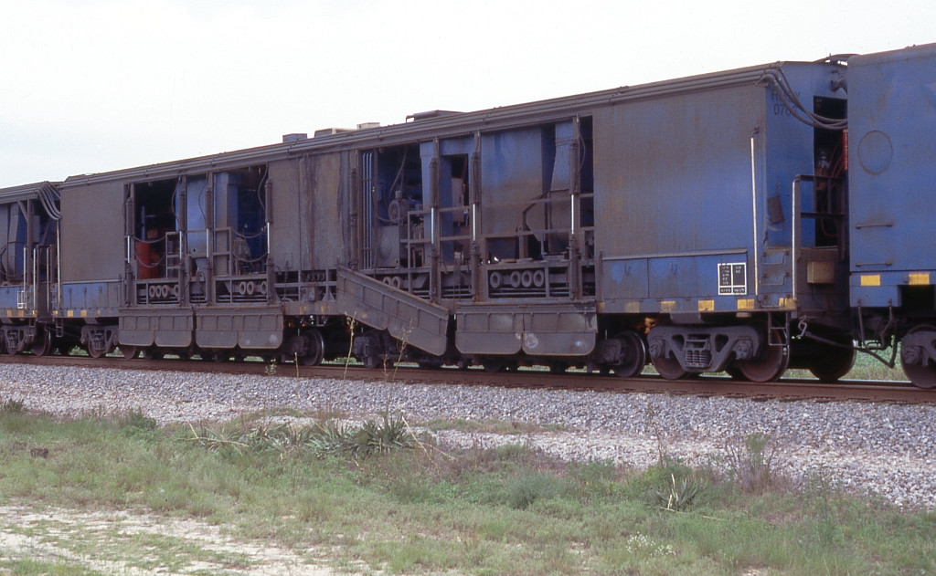 Pandrol Jackson railgrinder with covers down moving into position to start grinding